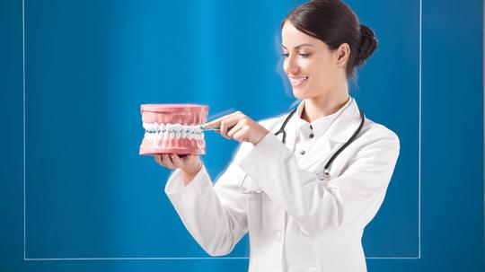 Female doctor standing by transparent monitor.