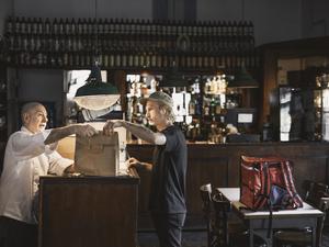 Delivery Person Receiving Order in a Restaurant