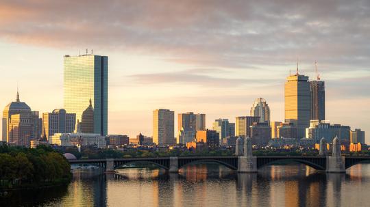 Boston, Massachusetts, USA downtown cityscape from across the Charles River at dawn.