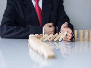 Stopping the domino effect concept for business solution, strategy and successful intervention