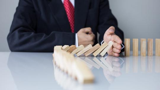 Stopping the domino effect concept for business solution, strategy and successful intervention