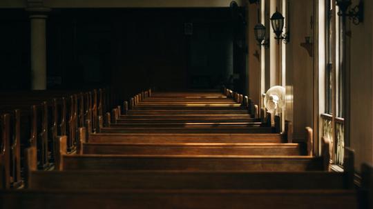 brown-wooden-church-bench-near-white-painted-wall-133699