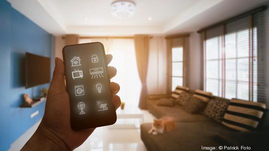 Mobile phone with smart home app in modern living room