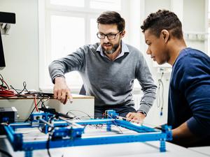 University Tutor Assisting Student With Technical Problem