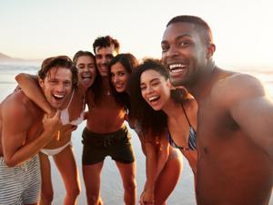 Group Of Friends Posing For Selfie Together On Beach Vacation