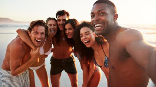 Group Of Friends Posing For Selfie Together On Beach Vacation