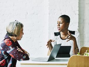 Female financial advisor in discussion with client in office conference room