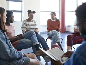 Students in group therapy meeting with instructor