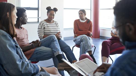 Students in group therapy meeting with instructor