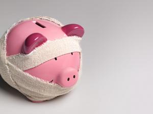 Ill piggy bank with bandages