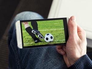 Watching a football match live streamed on mobile phone