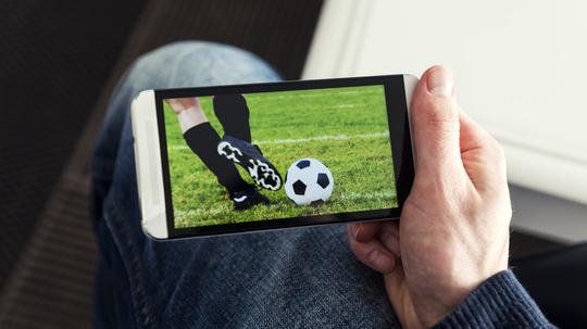 Watching a football match live streamed on mobile phone