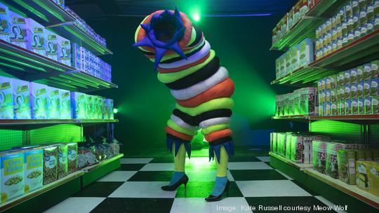 A Meow Wolf character in an Omega Mart aisle.