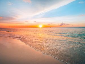 Sunset sea landscape. Colorful ocean beach sunrise. Beautiful beach scenery with calm waves and soft sandy beach. Empty tropical landscape, horizon with scenic coast view. Colorful nature sea sky