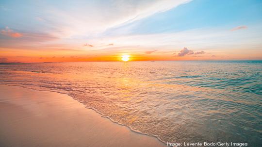 Sunset sea landscape. Colorful ocean beach sunrise. Beautiful beach scenery with calm waves and soft sandy beach. Empty tropical landscape, horizon with scenic coast view. Colorful nature sea sky