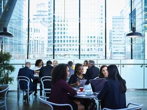 Professional businesswomen using laptops in conference centre