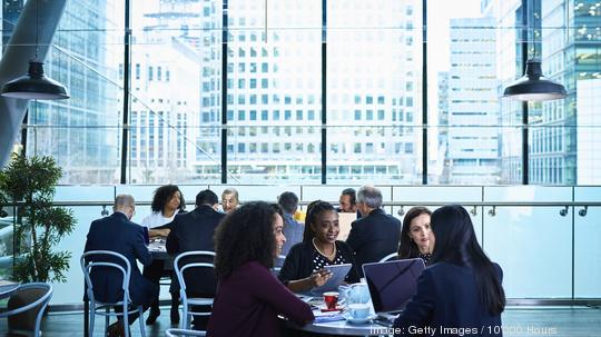 Professional businesswomen using laptops in conference centre