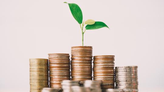 Coins stack and seedling on top.