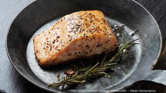 Fried salmon fillet in a frying pan