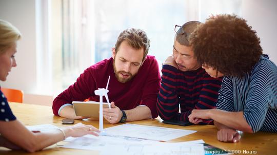 Group of coworkers discussing green energy project