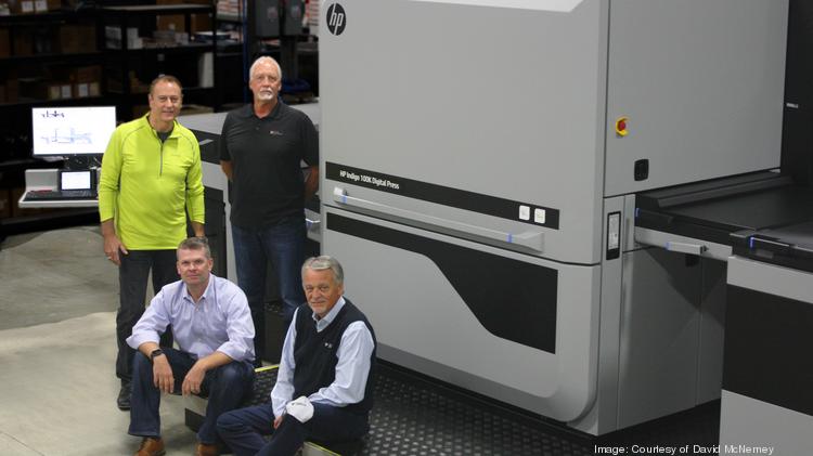 Think Patented partners Ken McNerney, Dale Lunce, David McNerney and Niels Winther stand near the new HP Indigo 100K digital press at the company's Miamisburg headquarters.