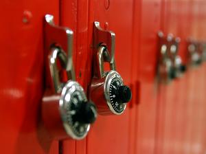 Combination locks on a row of red high school lockers