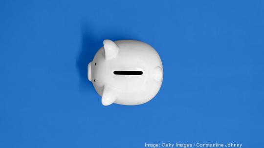 Top View of White Piggy Bank on Yellow Background