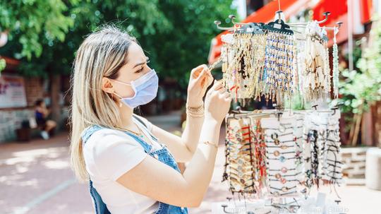 women enjoy shopping for jewelry at city street