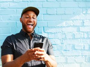 Man laughing with smart phone