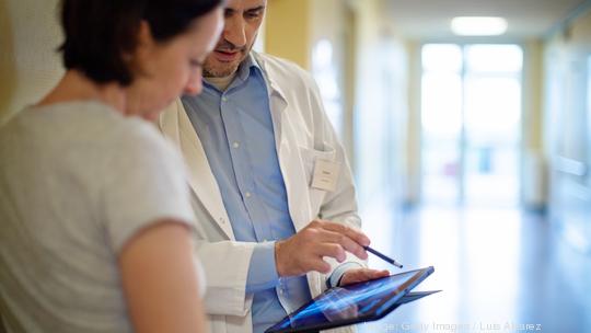 Doctor showing x-ray to a woman patient