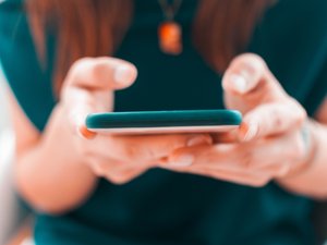 A young woman is using her smartphone