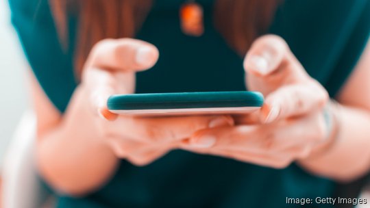 A young woman is using her smartphone