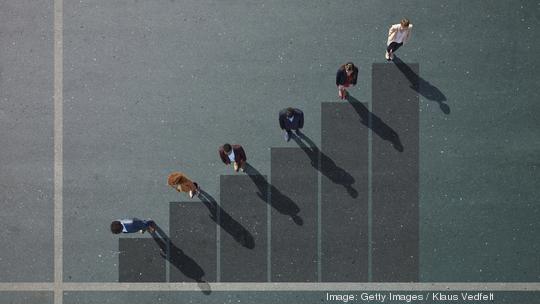 Businesspeople standing on painted bar chart on asphalt