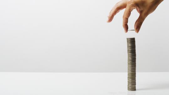 Woman stacking coins