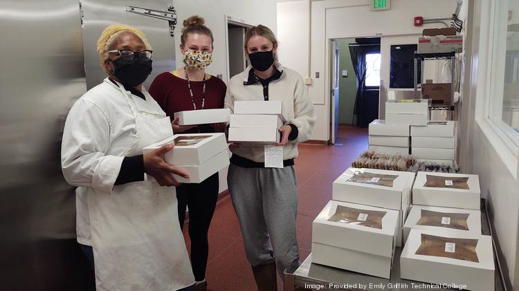 Emily Griffith Culinary Quick Start student Valerie (left) hands pies to customers before Thanksgiving.