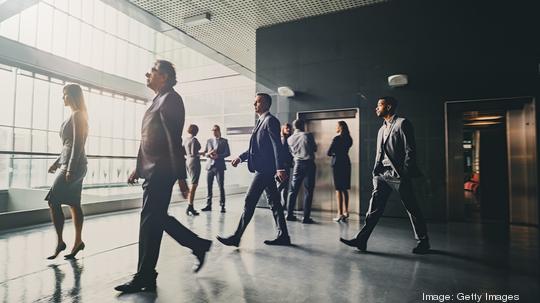 Business people in lobby walking