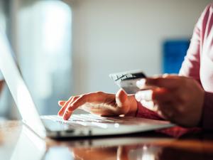 Woman shopping online with a credit card and pc.