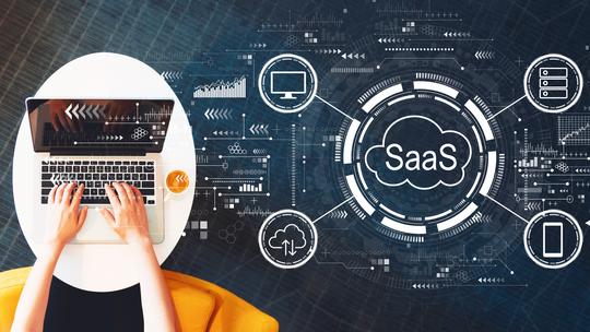 SaaS - software as a service concept with person using a laptop