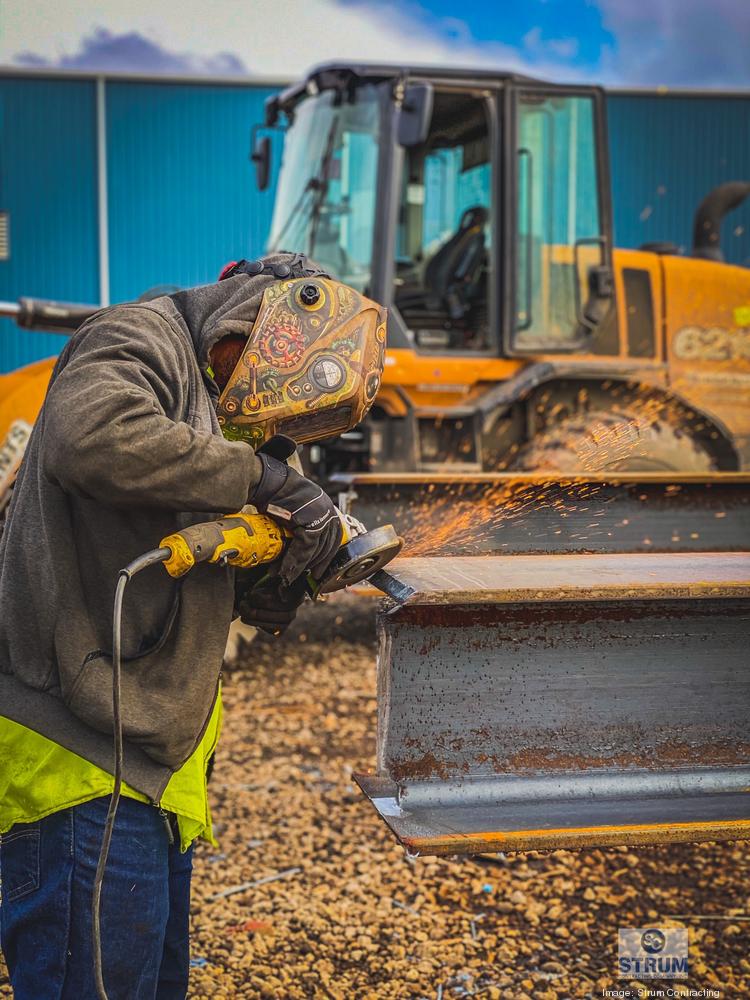 Construction at Tradepoint's port where steel beams were driven into the ground to strengthen ground bearing capacity, and steel welding.