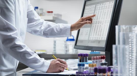 Scientist using computer in lab