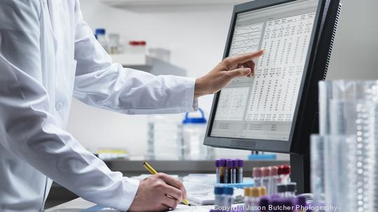 Scientist using computer in lab