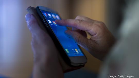 Hands of senior touching smartphone - stock photo getty