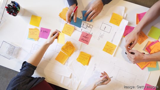 Young workers in creative office space. - stock photo