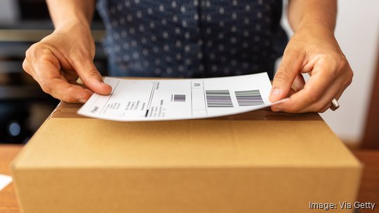 Woman preparing package for online delivery