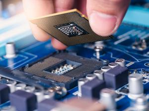 the technician laying the CPU chip in the motherboard's socket