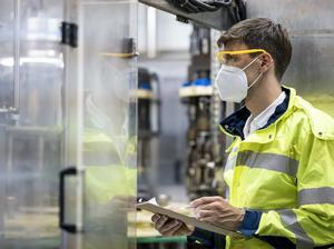 Food and Beverage Factory Male production line operator working at automated conveyor belt. Industry, Business, Processing, Quality Control. Production.