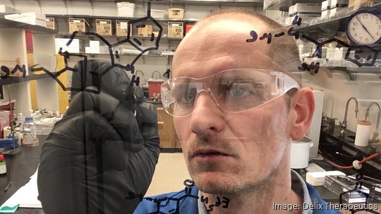 david e. olson phd draws chemical structures on a fume hood