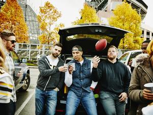 Friends toasting at tailgating party before game