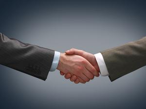 Handshake - Hand holding on black background - stock photo