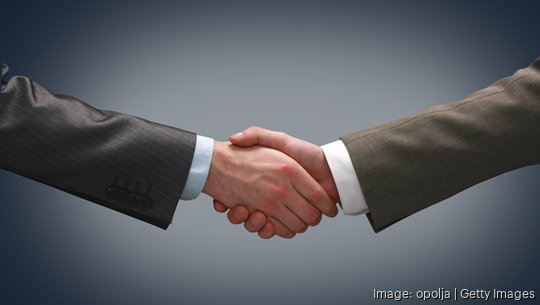 Handshake - Hand holding on black background - stock photo